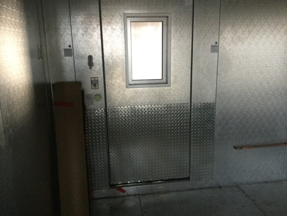 a bathroom with a glass door and a window